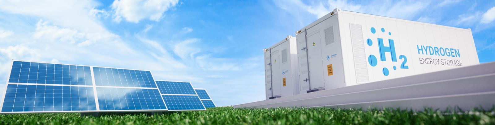 Field with solar panels and white hydrogen production containers