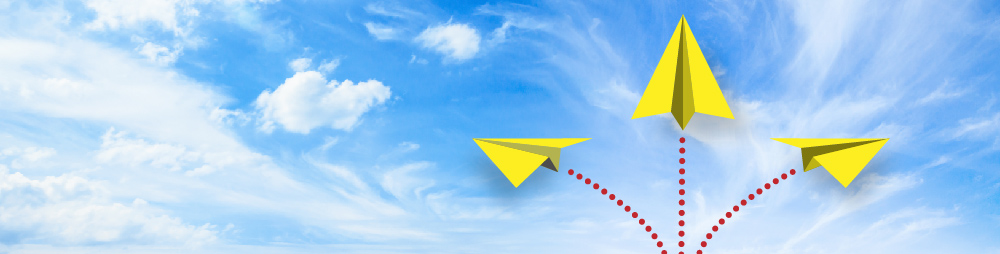 Three yellow paper planes performing acrobatics - signifying innovation development in Dorset. 
