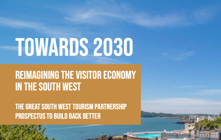 Cover of the Towards 2030 Report includes a beach scene looking out to sea from a cliff top on a sunny day